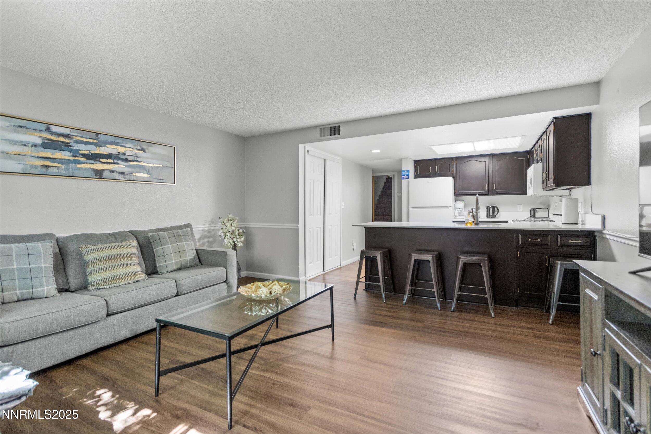 400 Claremont Street Reno, NV 89502 - Photo 19 of 32 a living room with furniture a wooden floor and kitchen view