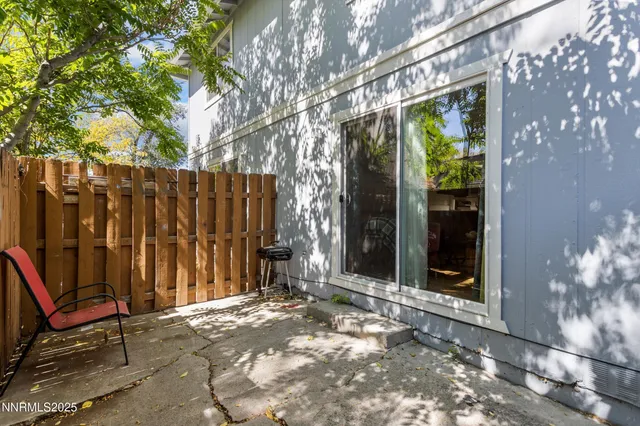 a view of backyard with tub and wooden fence