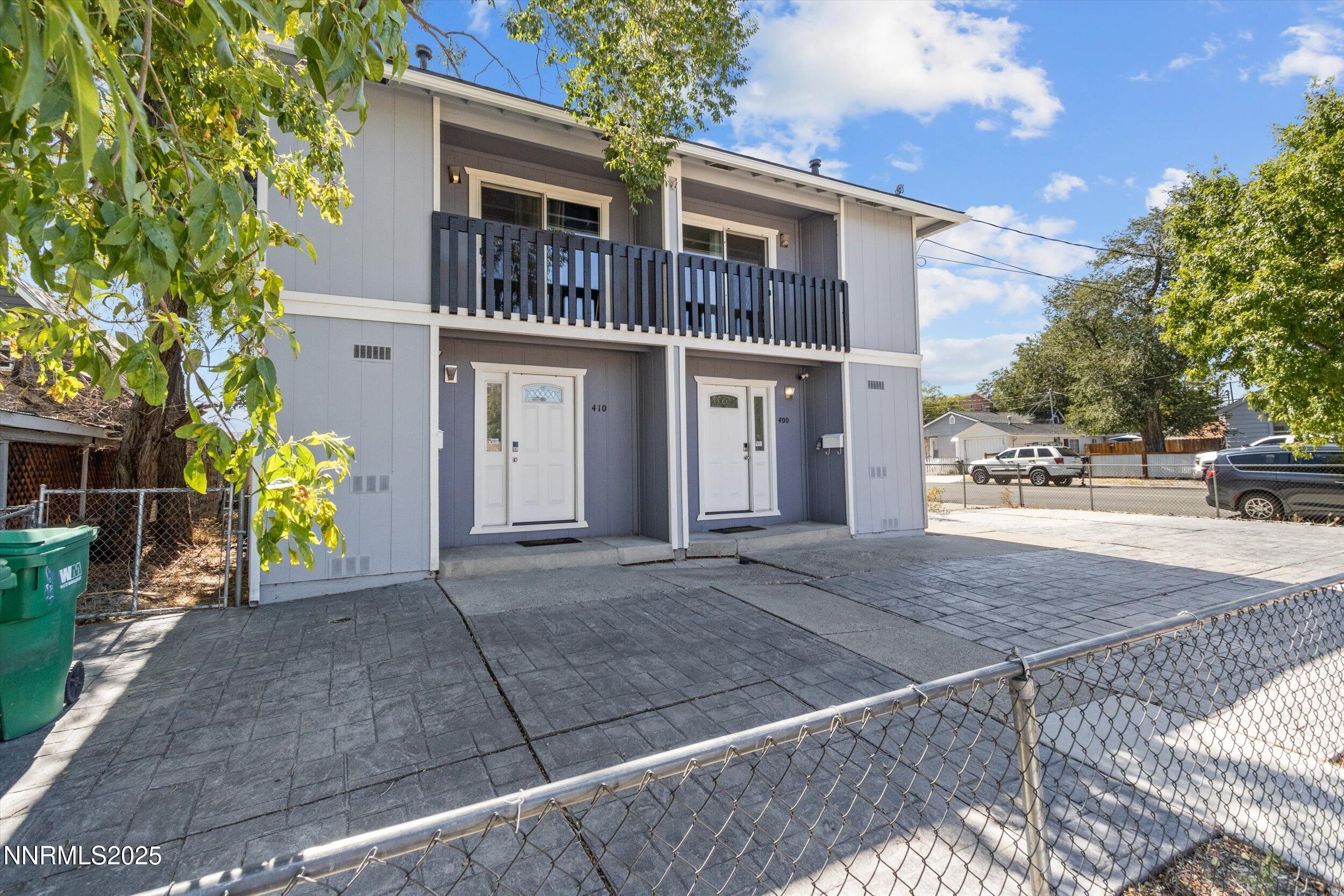 400 Claremont Street Reno, NV 89502 - Photo 24 of 32 a view of a brick house with many windows next to a yard