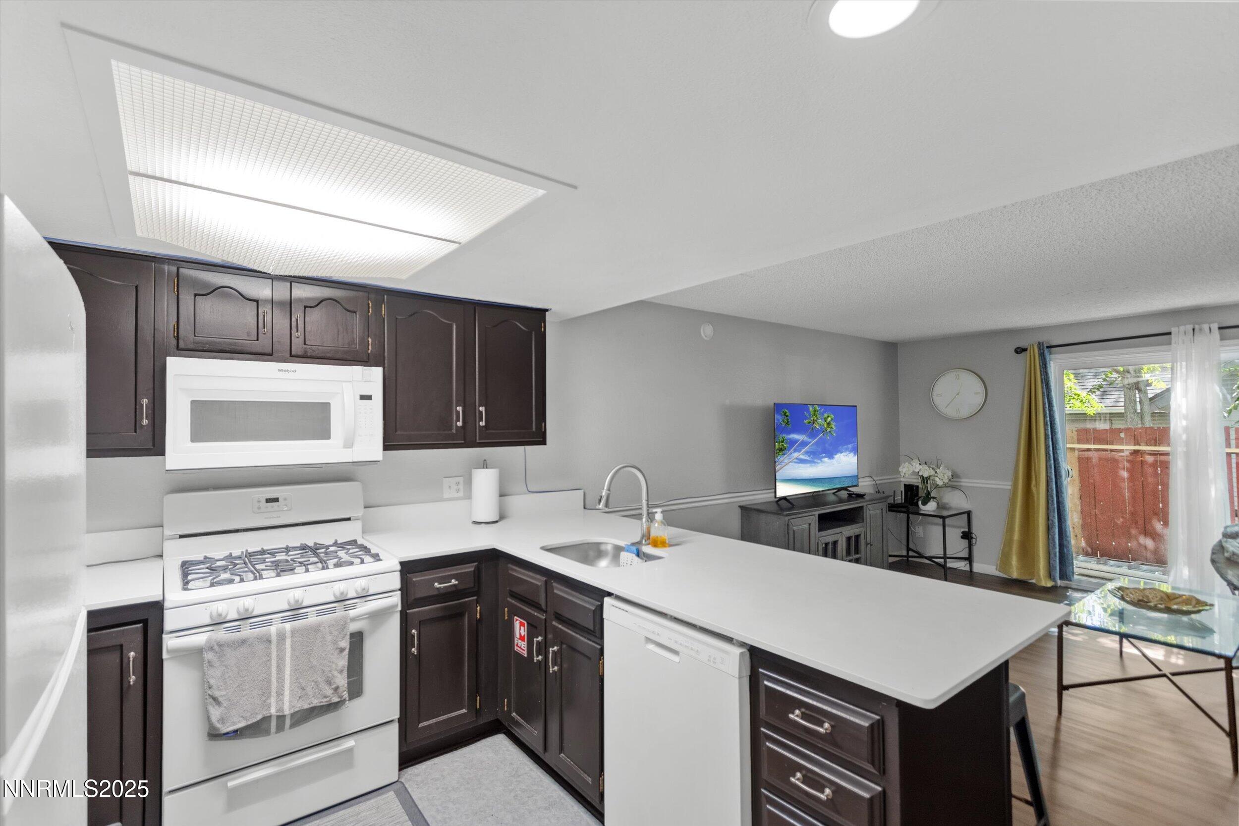 400 Claremont Street Reno, NV 89502 - Photo 26 of 32 a kitchen with a stove a sink and a microwave