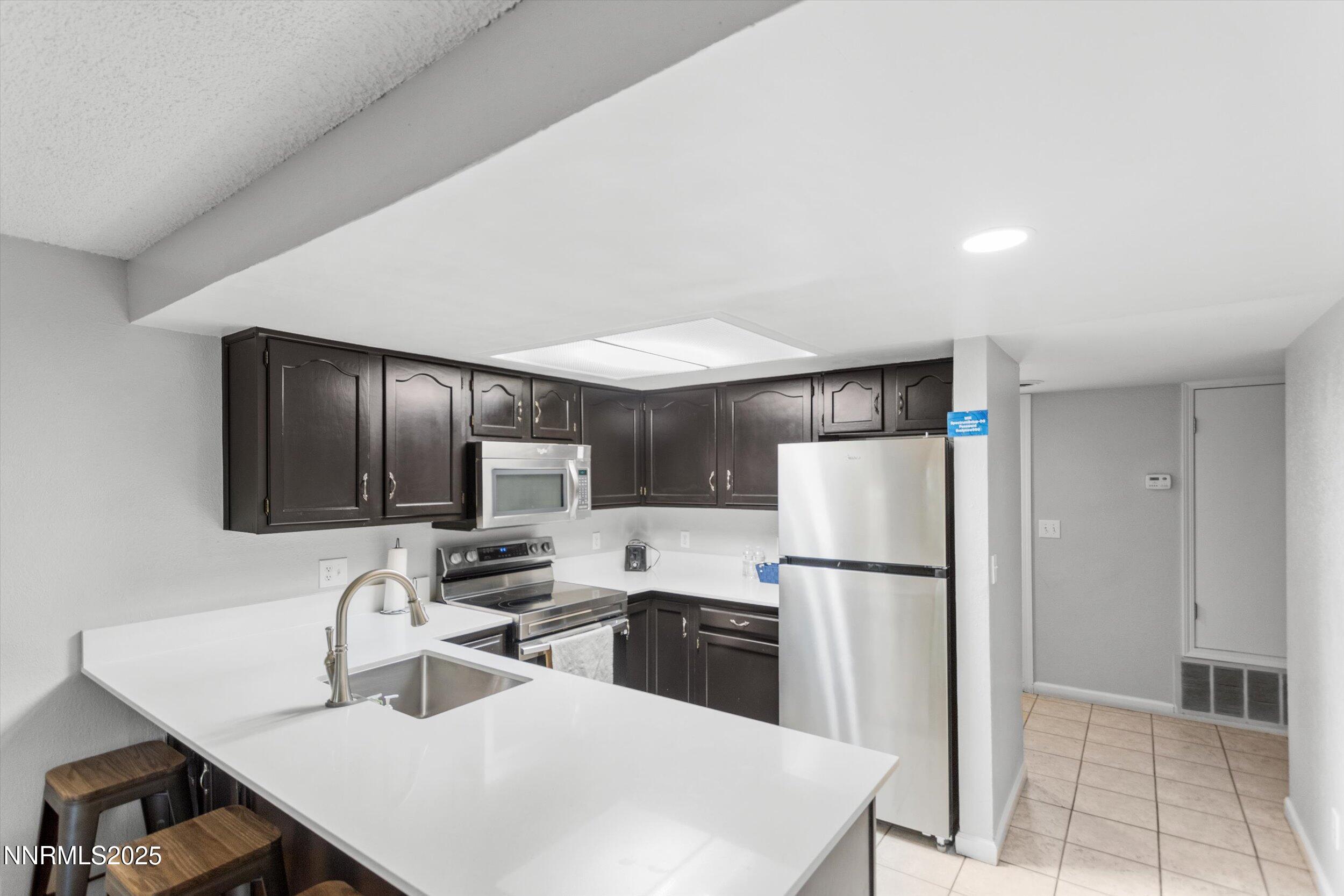 400 Claremont Street Reno, NV 89502 - Photo 29 of 32 a kitchen with a refrigerator a sink and a stove