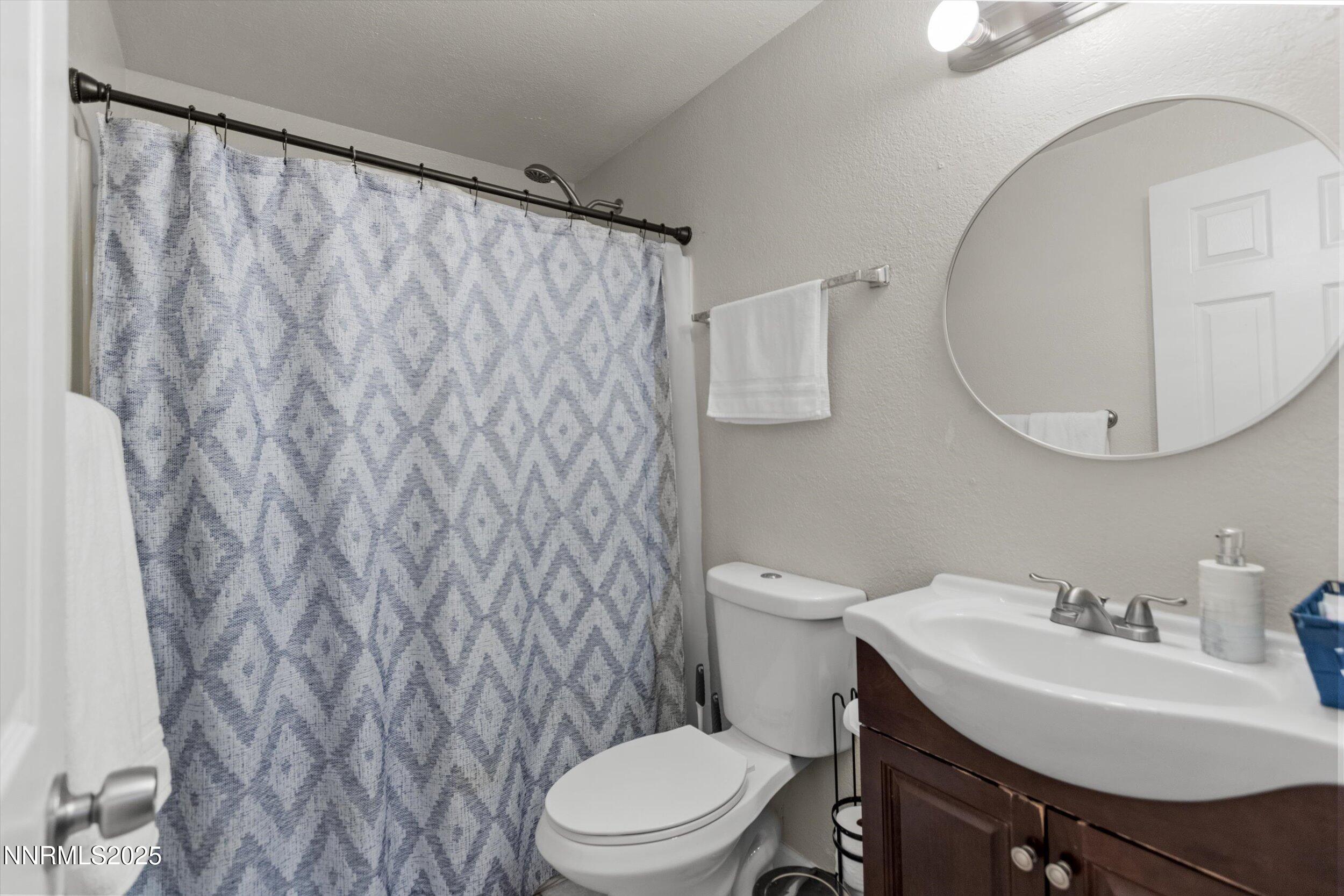 400 Claremont Street Reno, NV 89502 - Photo 6 of 32 a bathroom with a sink a toilet and a mirror