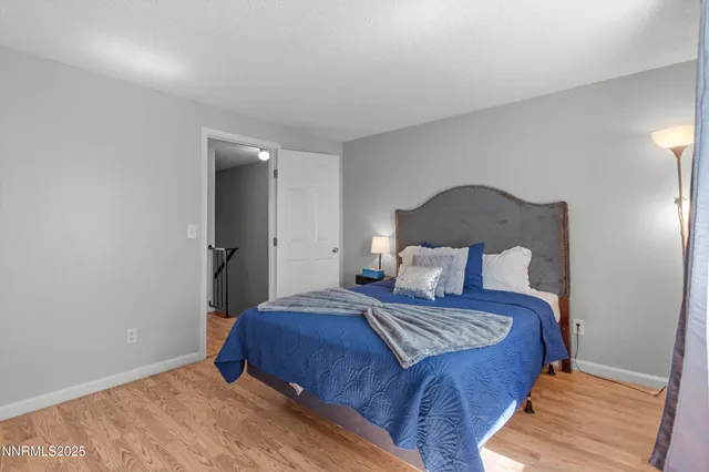 a bedroom with a bed and a lamp