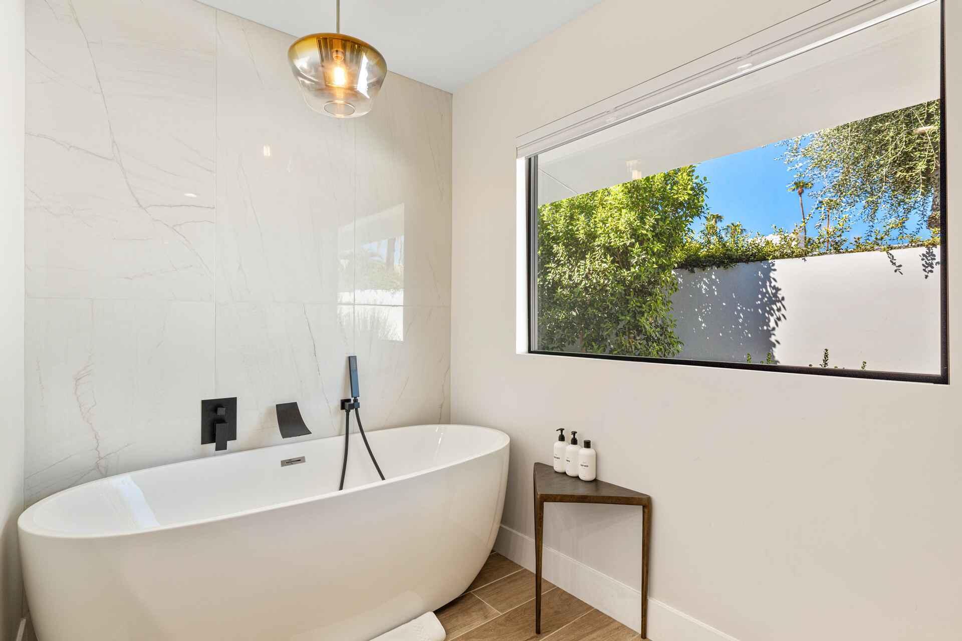 45655 Apache Road Indian Wells, CA 92210 - Photo 13 of 31 a bathroom with a bathtub and a window