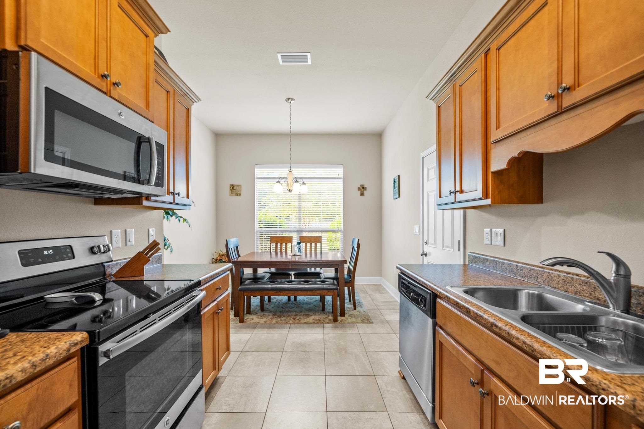 17069 Russet Court Foley, AL 36535 - Photo 8 of 27 Kitchen with pendant lighting, appliances with stainless steel finishes, sink, a notable chandelier, and light tile patterned flooring