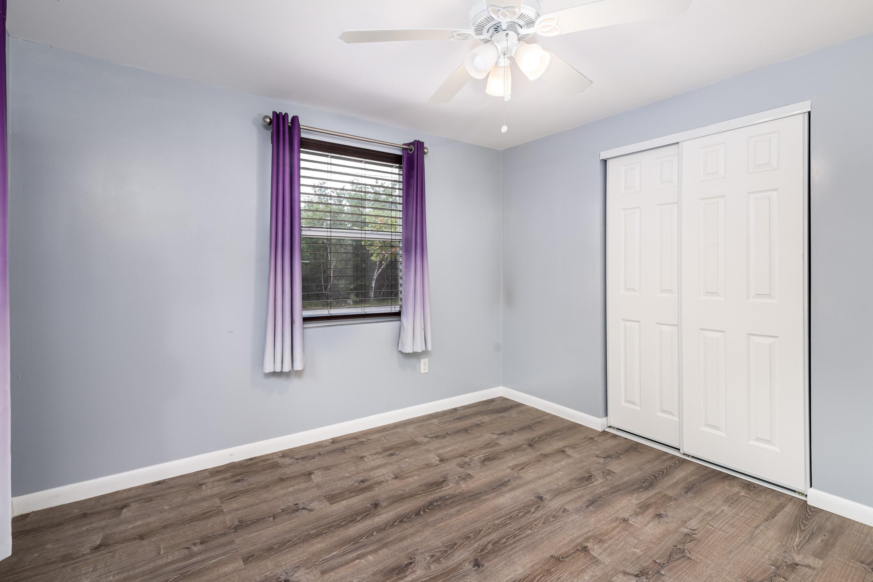 30023 Pine Channel Road Big Pine Key, FL 33043 - Photo 12 of 31 a view of an empty room with wooden floor and a window