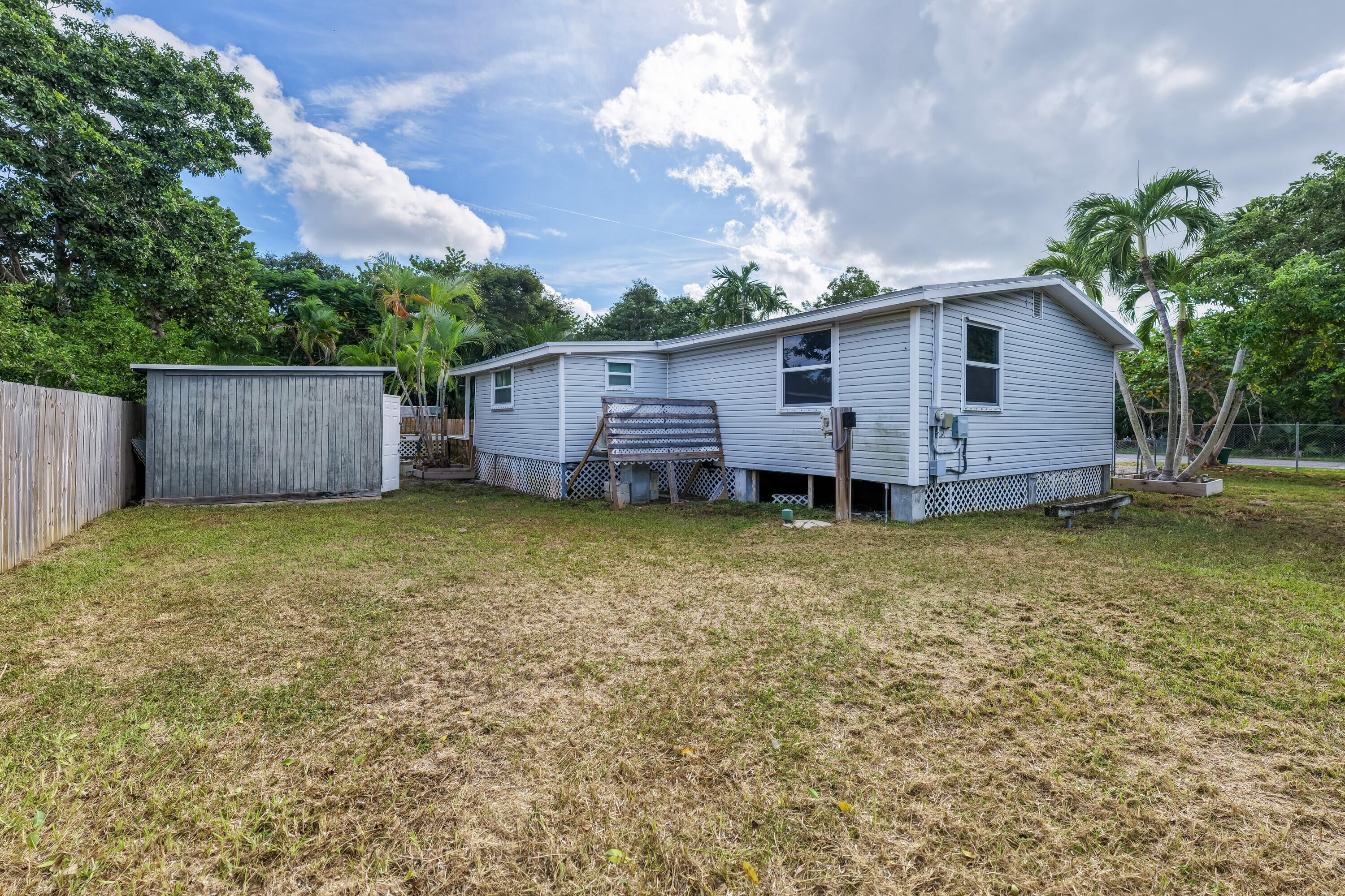 30023 Pine Channel Road Big Pine Key, FL 33043 - Photo 21 of 31 a view of a house with a backyard and wooden fence