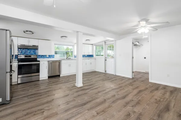 a view of a kitchen with a stove cabinets and wooden floor