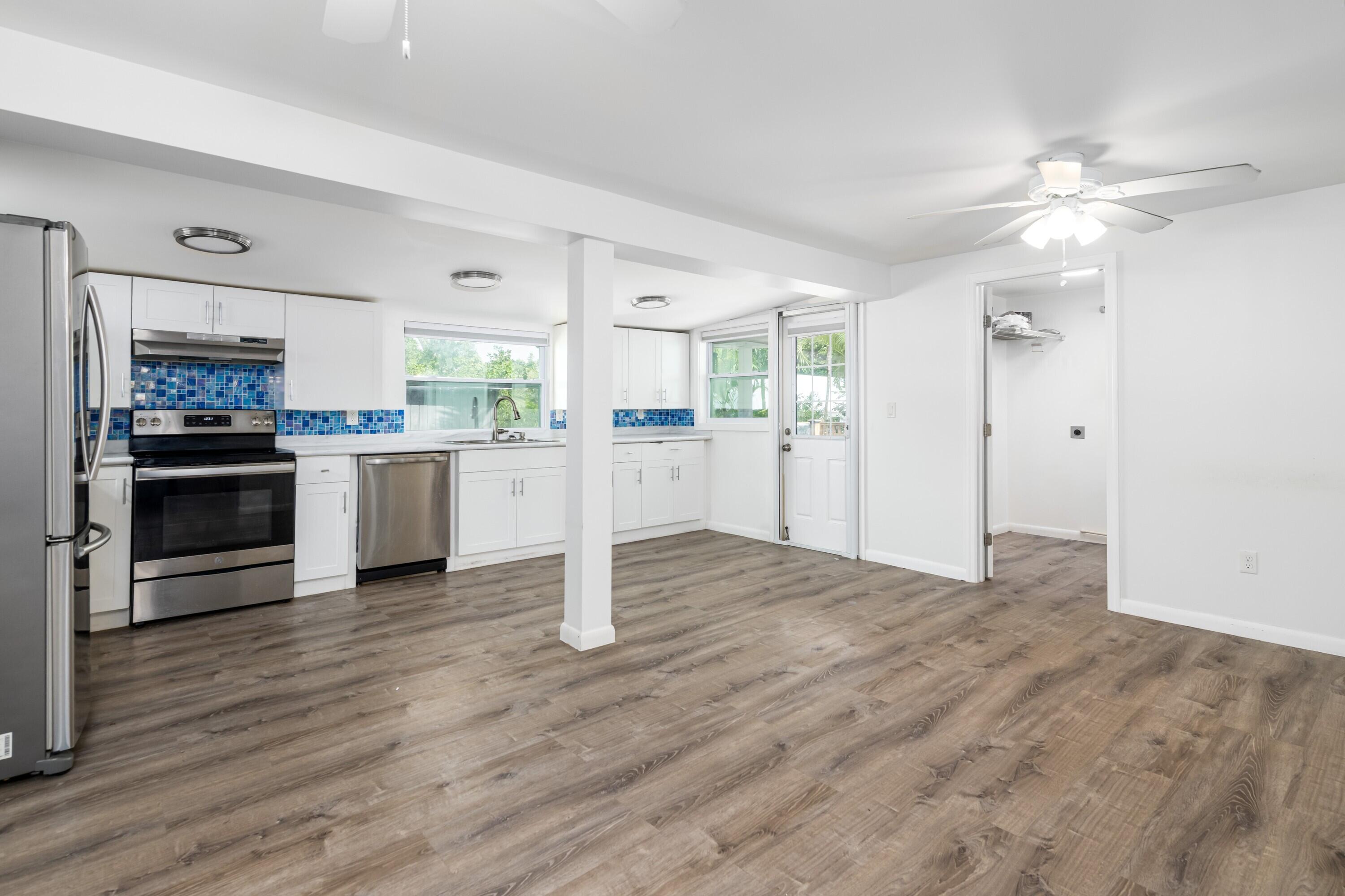 30023 Pine Channel Road Big Pine Key, FL 33043 - Photo 5 of 31 a view of a kitchen with a stove cabinets and wooden floor