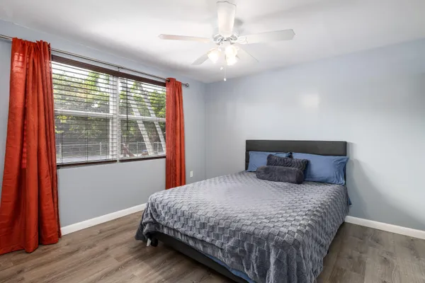 a bedroom with a large bed and a large window