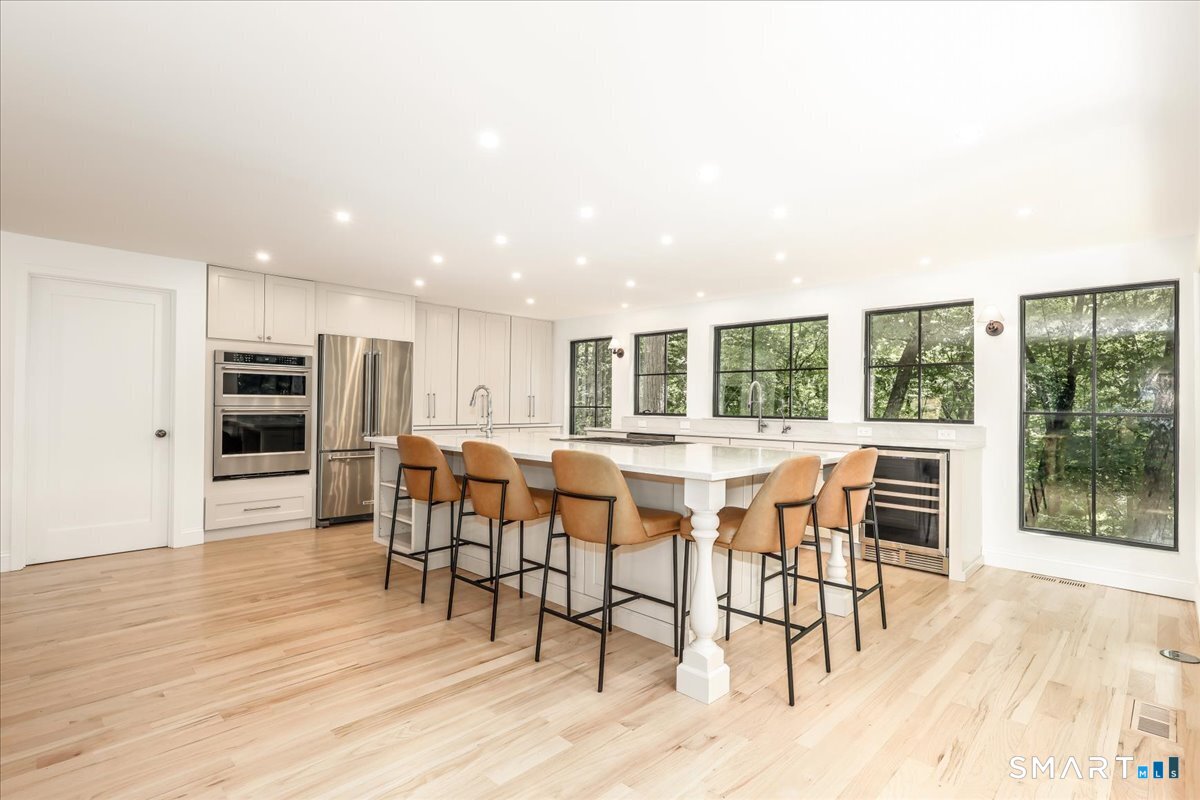 256 Wilton Road East Ridgefield, CT 06877 - Photo 9 of 40 a view of a dining room with furniture and wooden floor