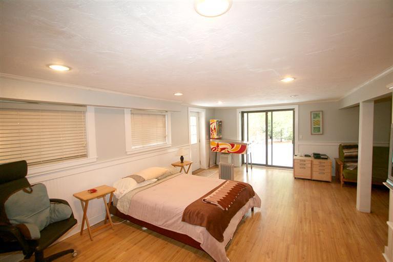 272 Pine Ridge Road Cotuit, MA 02635 - Photo 16 of 19 a spacious bedroom with a bed and wooden floor