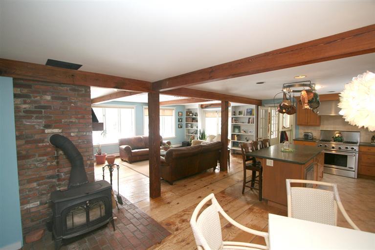 272 Pine Ridge Road Cotuit, MA 02635 - Photo 6 of 19 a living room with furniture a flat screen tv and a floor to ceiling window