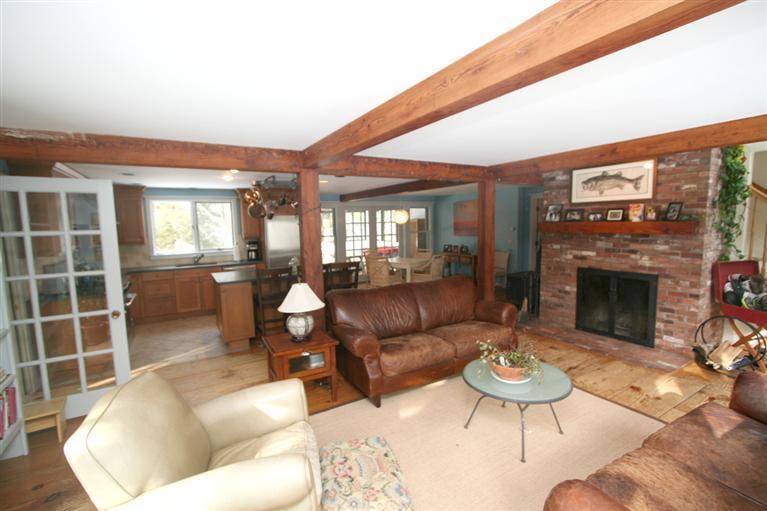 272 Pine Ridge Road Cotuit, MA 02635 - Photo 7 of 19 a living room with furniture a fireplace and a large window