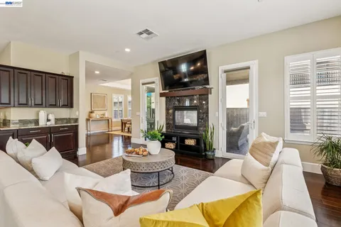 a living room with fireplace furniture and a flat screen tv