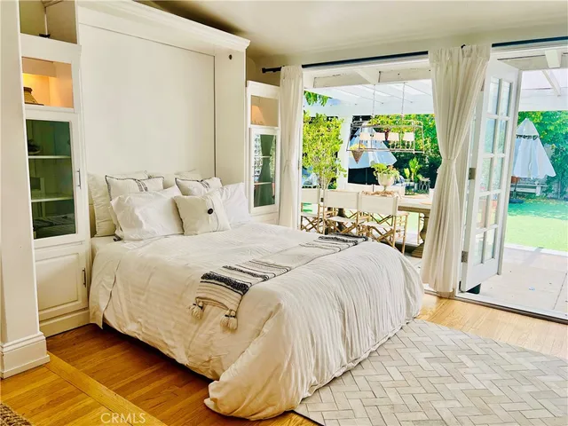 a bed sitting in a bedroom next to a window