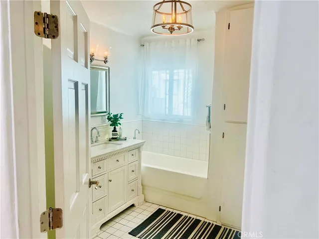 a bathroom with a sink a mirror and a shower
