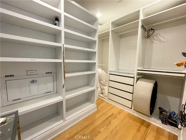 a view of walk in closet with empty racks