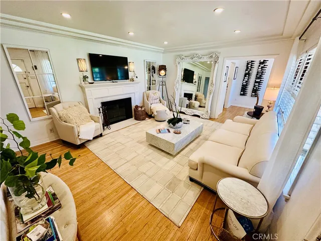 a living room with furniture fireplace and flat screen tv