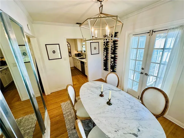 a view of a livingroom with furniture wooden floor and chandelier