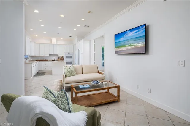 a living room with furniture and a view of kitchen