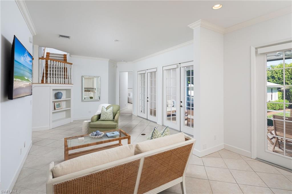 155 1st Avenue South Naples, FL 34102 - Photo 14 of 27 a living room with furniture and a flat screen tv