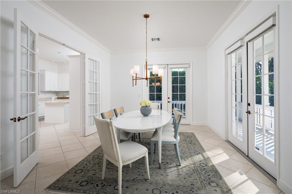 155 1st Avenue South Naples, FL 34102 - Photo 16 of 27 a view of a dining room with furniture window and wooden floor