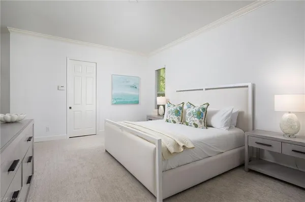 a bedroom with a bed and a night stand