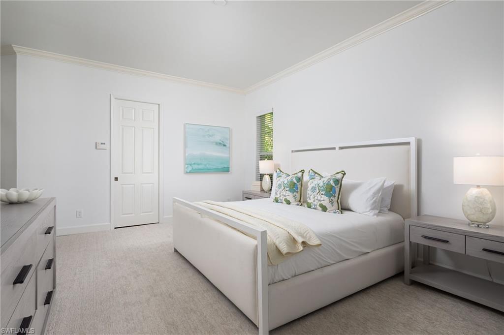 155 1st Avenue South Naples, FL 34102 - Photo 17 of 27 a bedroom with a bed and a night stand