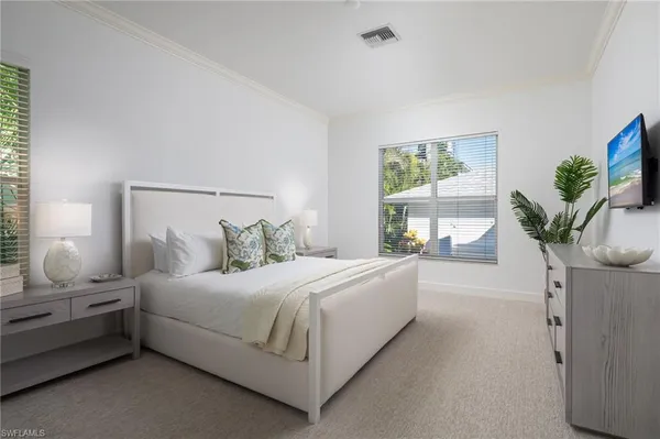 a bedroom with a bed potted plant with the window