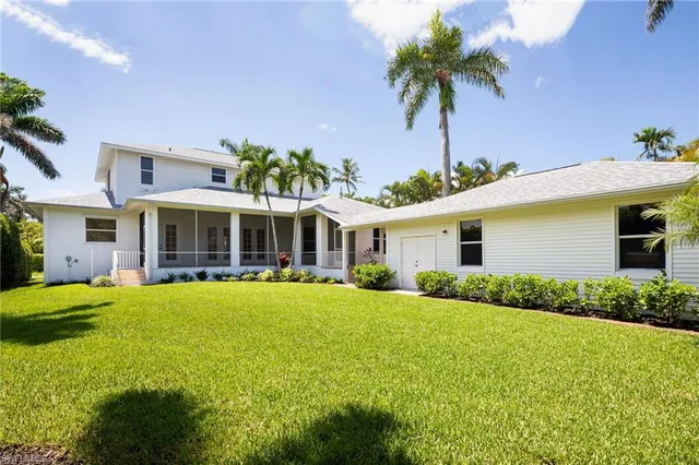 a front view of house with yard and outdoor seating