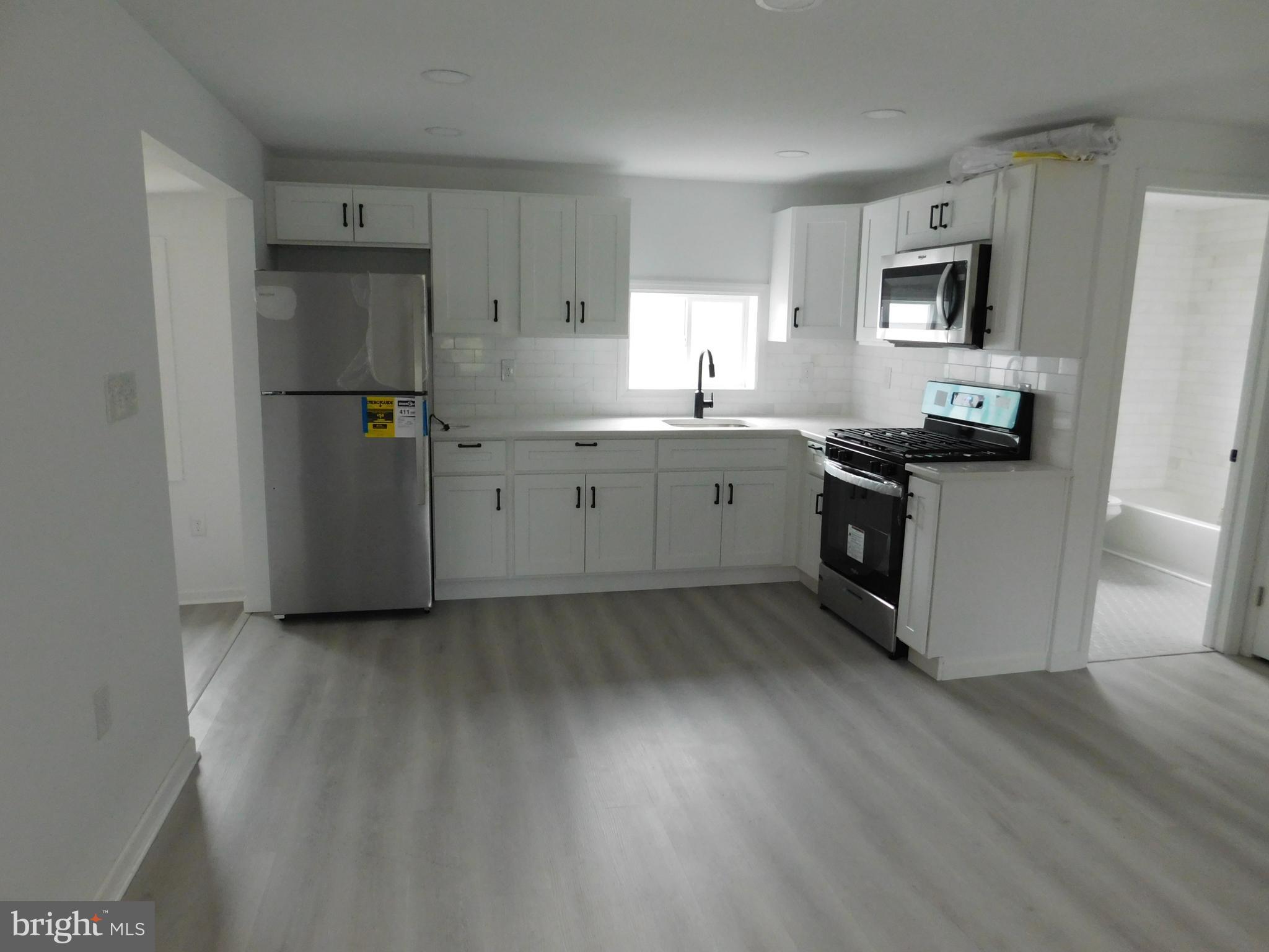 511 Cherry Street, Unit 4 Roebling, NJ 08554 - Photo 4 of 14 a kitchen with granite countertop a sink stove and refrigerator