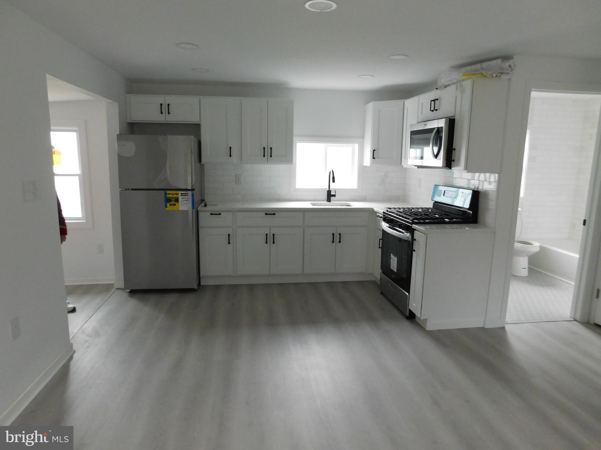 511 Cherry Street, Unit 4 Roebling, NJ 08554 - Photo 5 of 14 a kitchen with cabinets and wooden floor