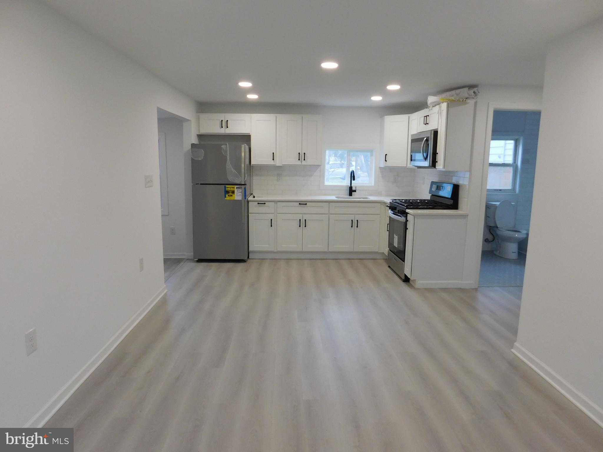 511 Cherry Street, Unit 4 Roebling, NJ 08554 - Photo 6 of 14 a kitchen with a refrigerator and a counter top space