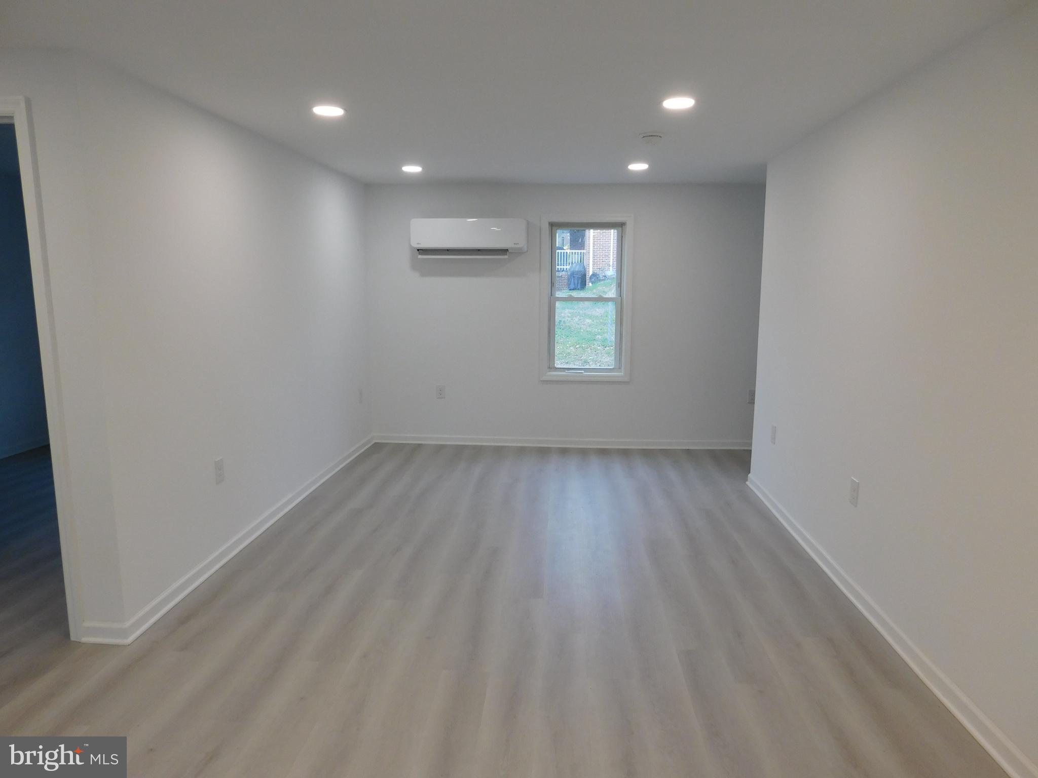 511 Cherry Street, Unit 4 Roebling, NJ 08554 - Photo 7 of 14 an empty room with wooden floor and windows