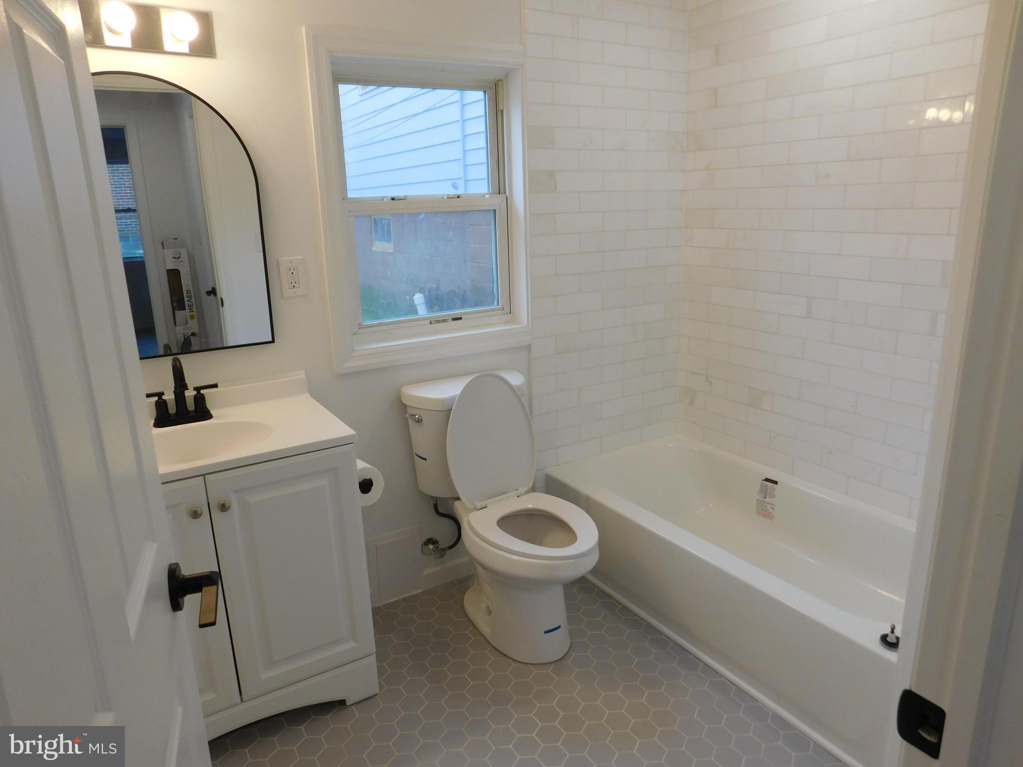 511 Cherry Street, Unit 4 Roebling, NJ 08554 - Photo 10 of 14 a bathroom with a sink a toilet and shower