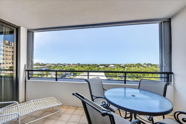 a view of a chairs and table in a balcony