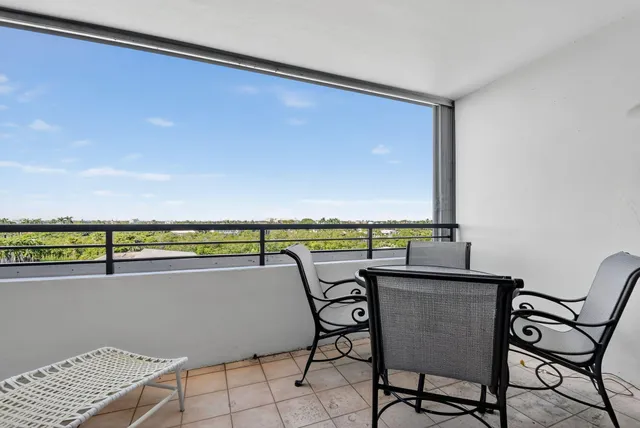a view of swimming pool with outdoor seating and city view