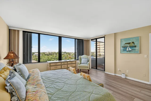 a bedroom with furniture and a large window