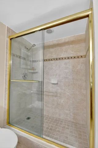 a bathroom with a glass shower door