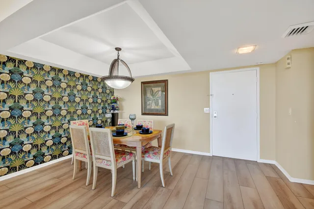 a view of a dining room with furniture wooden floor and chandelier