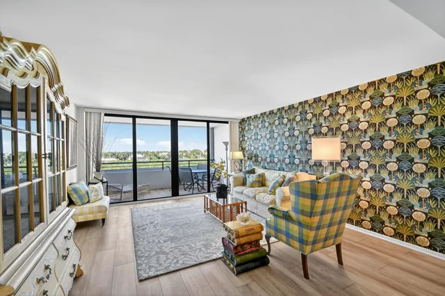 a living room with furniture and a floor to ceiling window