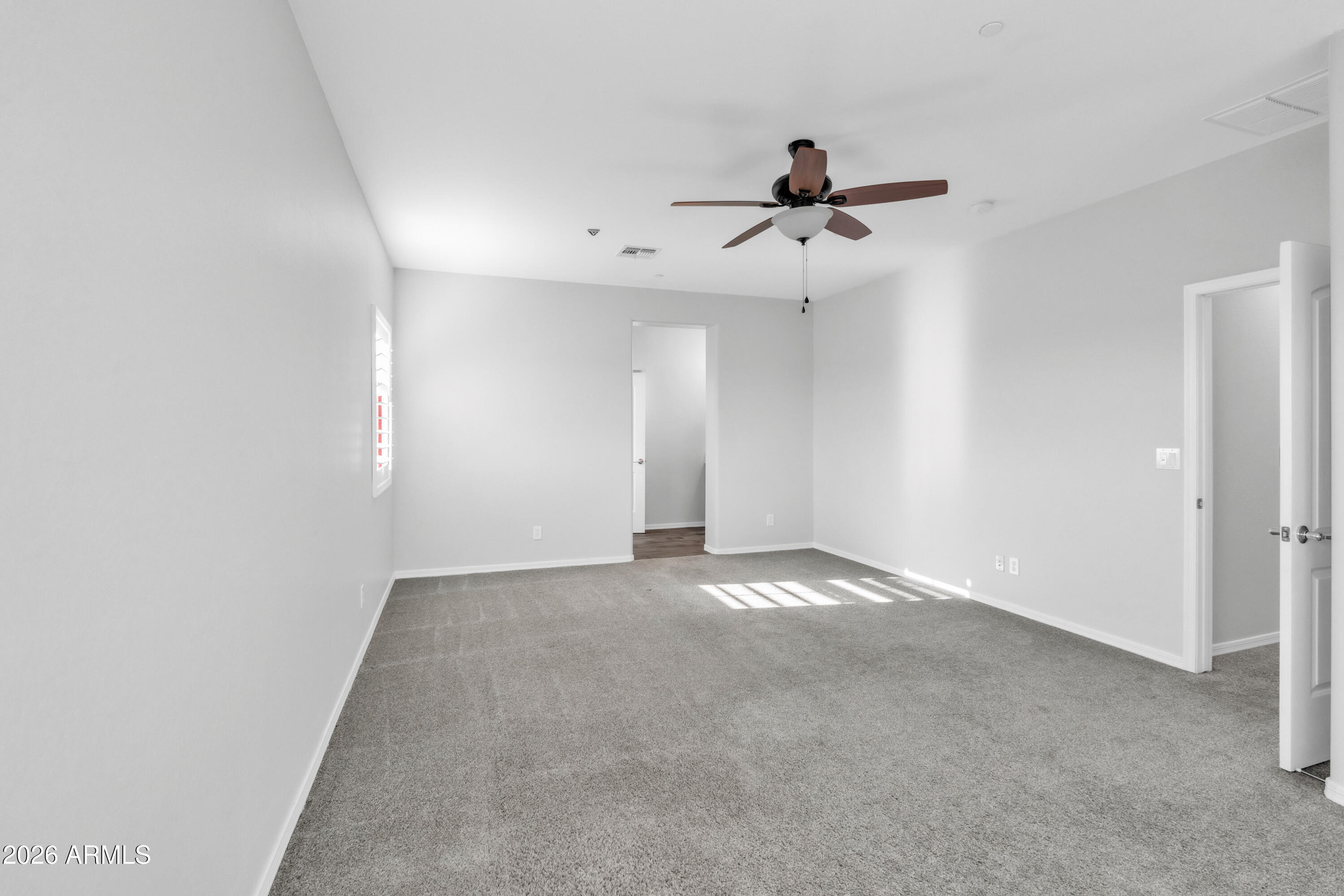 1615 West Red Fox Road Phoenix, AZ 85085 - Photo 38 of 64 an empty room with windows and fan