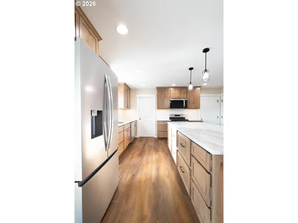 a large kitchen with a sink and cabinets
