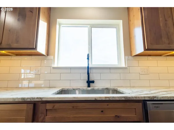 a kitchen with granite countertop a sink and a window