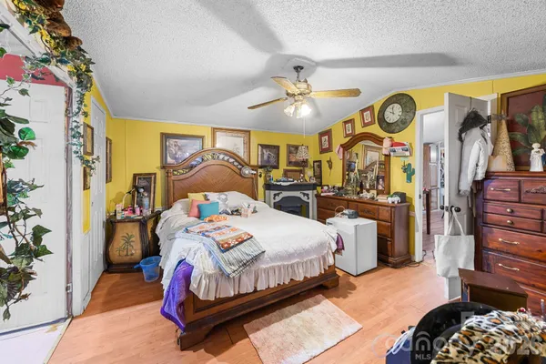 a bedroom with a bed and ceiling fan