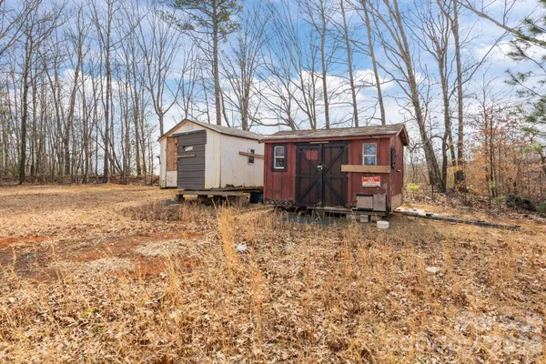 a view of a house with a yard and tree