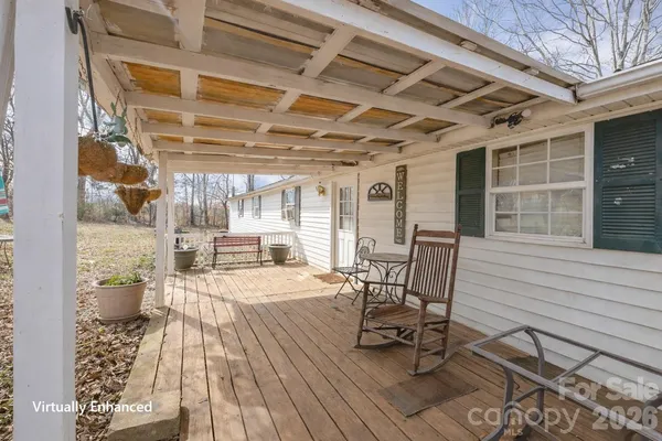 a view of a patio with table and chairs and wooden floor