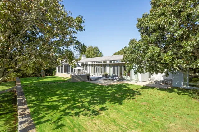 a view of a house with backyard porch and sitting area