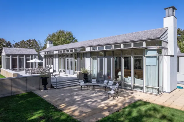 a living room with furniture and large windows